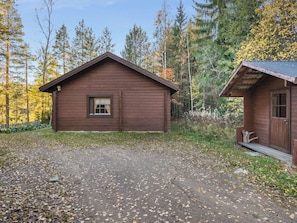 A rustic cabin with a wooden exterior, a small window, and a porch. - Suvituuli by Interhome (Punkaharju)