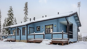 Un edificio blu con un portico, una finestra e una porta.