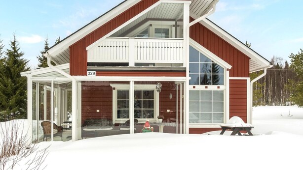 A two-story house with a large glass front and a balcony. - Pyrykieppi by Interhome (Rovaniemi)