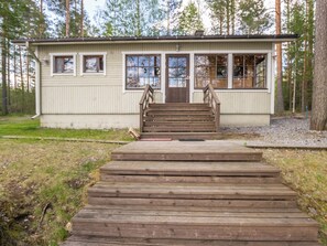 A small building with a wooden staircase leading to a door, surrounded by trees. - Mäntyrinne by Interhome (Kerimäki)