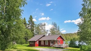 A red house with a porch and a gravel driveway. - Pajaranta by Interhome (Hartola)