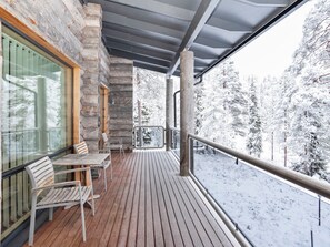 A wooden deck with a view of snow-covered trees. - Vacation home Leija by Interhome (Kuusamo)