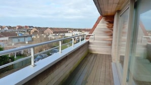 Un balcone con vista su case e cielo sereno.