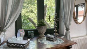 A wooden counter with a marble top, a potted plant, a candle holder, and a tray of items. - Hiddensee by Interhome (Dargun)