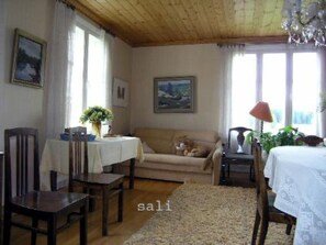 Relax in this inviting space with a dining table, sofa, and comfortable seating.