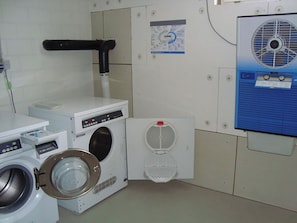 A laundry room with a washing machine, dryer, and a ventilation system. - Blumenweg 2 Appartement/Fewo 4-Bettwohnung by Interhome (Engelberg)