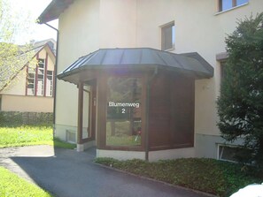A building with a corner entrance, a sign reading 'Blumenweg 2', and a small garden area. - Blumenweg 2 Appartement/Fewo 4-Bettwohnung by Interhome (Engelberg)