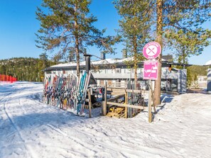 A ski lodge with a ski rental area and a sign indicating a restaurant and bar.