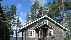 A log cabin with a front porch and a small staircase leading to the entrance. - Taivaanranta by Interhome (Pyhäjärvi)