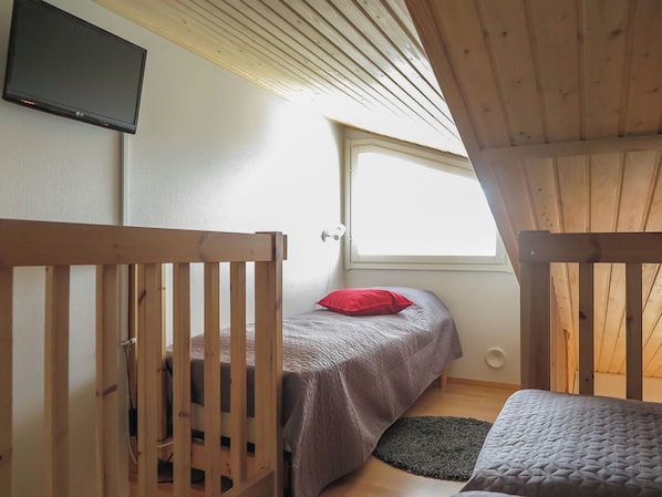 A bedroom with a bed, a window, and a TV mounted on the wall. - Levi star 1009 by Interhome (Kittilä)