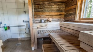 A wooden cabin with a sauna, a shower, and a window with a view of trees. - Vacation home Björn by Interhome (Kemiönsaari)