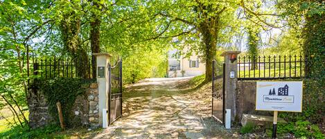 A gated entrance to a property with a sign indicating it is a Monchateau Ecole.