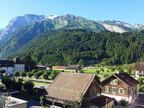 A mountain town with traditional buildings and a prominent mountain in the background.