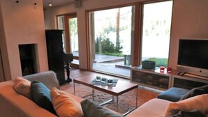 Un soggiorno moderno con un divano, un tavolino da caffè e una televisione.