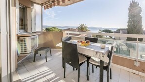 Varanda com mesa posta para refeições, com vista panorâmica.