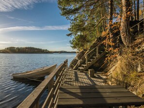 A wooden dock with boats and a staircase leading down to a body of water.