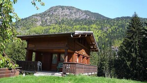 A wooden cabin with a porch and a view of a mountain. - Pierre Blanche by Interhome (Les Houches)