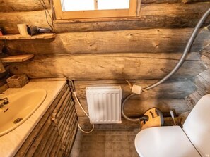 Bathroom features a bathtub, toilet, and radiator.