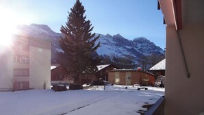 A snowy outdoor area with buildings and mountains in the background. - Neuschwändi 66 Appartement/Fewo 4-Bettwohnung by Interhome (Engelberg)