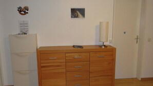 A room with a wooden dresser, a small framed picture on the wall, and a door. - Neuschwändi 66 Appartement/Fewo 4-Bettwohnung by Interhome (Engelberg)