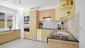 Fridge, dishwasher, highchair, cookware/dishes/utensils