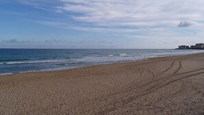 Ein Strand mit blauem Himmel und Meereswellen.