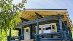 A log cabin with a porch, wooden steps, and a window. - Vacation home Norppa by Interhome (Puumala)