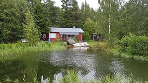 A small house by a pond with a dock extending into the water. - Soukonranta by Interhome (Pori)
