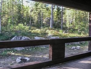 A wooden deck with a view of a forested area. - Klz 10. opaali by Interhome (Sotkamo)