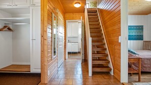 A wooden interior with a staircase leading to a bedroom. - Talvikki by Interhome (Kuopio)
