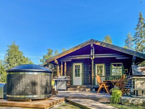 A log cabin with a porch, a grill, and a hot tub. - Hartolan ilo by Interhome (Hartola)
