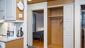A compact room with a kitchenette, a bed, and a walk-in closet. - Alppitalo punatähti 7 as 2 by Interhome (Nilsiä)