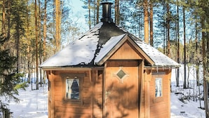 A wooden cabin with a pitched roof, a chimney, and a door with a diamond-shaped window. - Mäntyniemi by Interhome (Konnevesi)