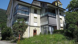 A multi-story residential building with large windows and balconies.