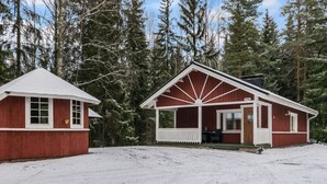Two red wooden cabins with white trim, surrounded by snow and trees. - Mäkimökki by Interhome (Somero)