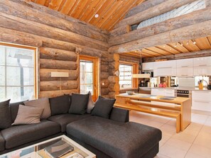 A log cabin interior with a living area, a kitchen, and a dining space. - Peikkola by Interhome (Kuusamo)