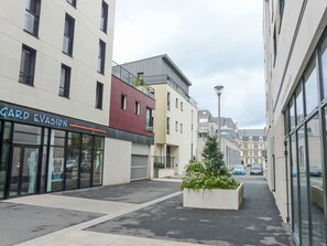 A modern urban street with a storefront named 'GARD EVASION'. - Nautica by Interhome (Saint Malo)