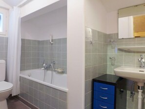 Ein Badezimmer mit Badewanne, Toilette und Waschbecken.