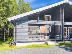 A two-story log cabin with a porch, a small window, and a door. - Ruka-linkki 3a by Interhome (Kuusamo)