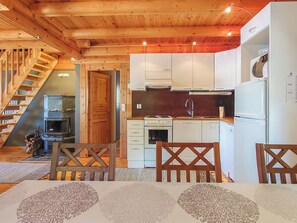 A wooden interior with a kitchen, dining area, and a staircase. - Honkala by Interhome (Soini)
