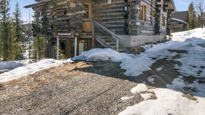 A log cabin with a staircase leading to the entrance, surrounded by snow and trees. - Rinnekieppi 1 by Interhome (Kuusamo)