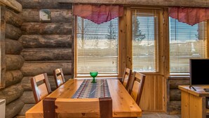 A wooden dining table with chairs, a green glass bowl, and a television on a wooden stand. - Rinnekieppi 1 by Interhome (Kuusamo)