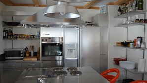A modern kitchen with stainless steel appliances, a microwave, and a sink. - Apartment Scapa by Interhome (Schönried)