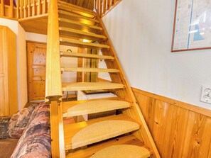 A wooden staircase with carpeted steps leading to a landing. - Uniranta by Interhome (Juuka)