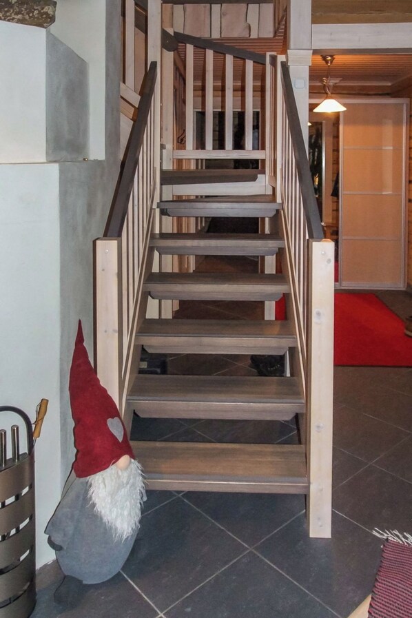 A wooden staircase with a gnome decoration at the bottom. - Seppola by Interhome (Kuusamo)