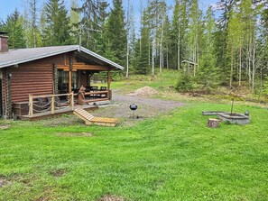 A wooden cabin with a porch, a grill, and a small deck. - Taukotupa by Interhome (Juupajoki)