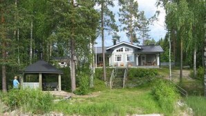 A house with a dock leading to a pond, surrounded by trees. - Varvali by Interhome (Konnevesi)