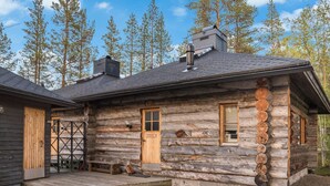 A log cabin with a wooden door, a window, and a chimney. - Ylläsparit as. 2 by Interhome (Ylläsjärvi)