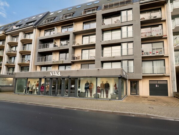 A multi-story building with a storefront labeled "VIVA".