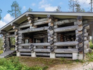 A log cabin with a porch and a chimney.